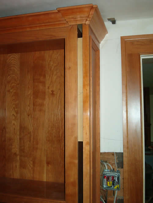 Picture of crown molding held off ceiling.